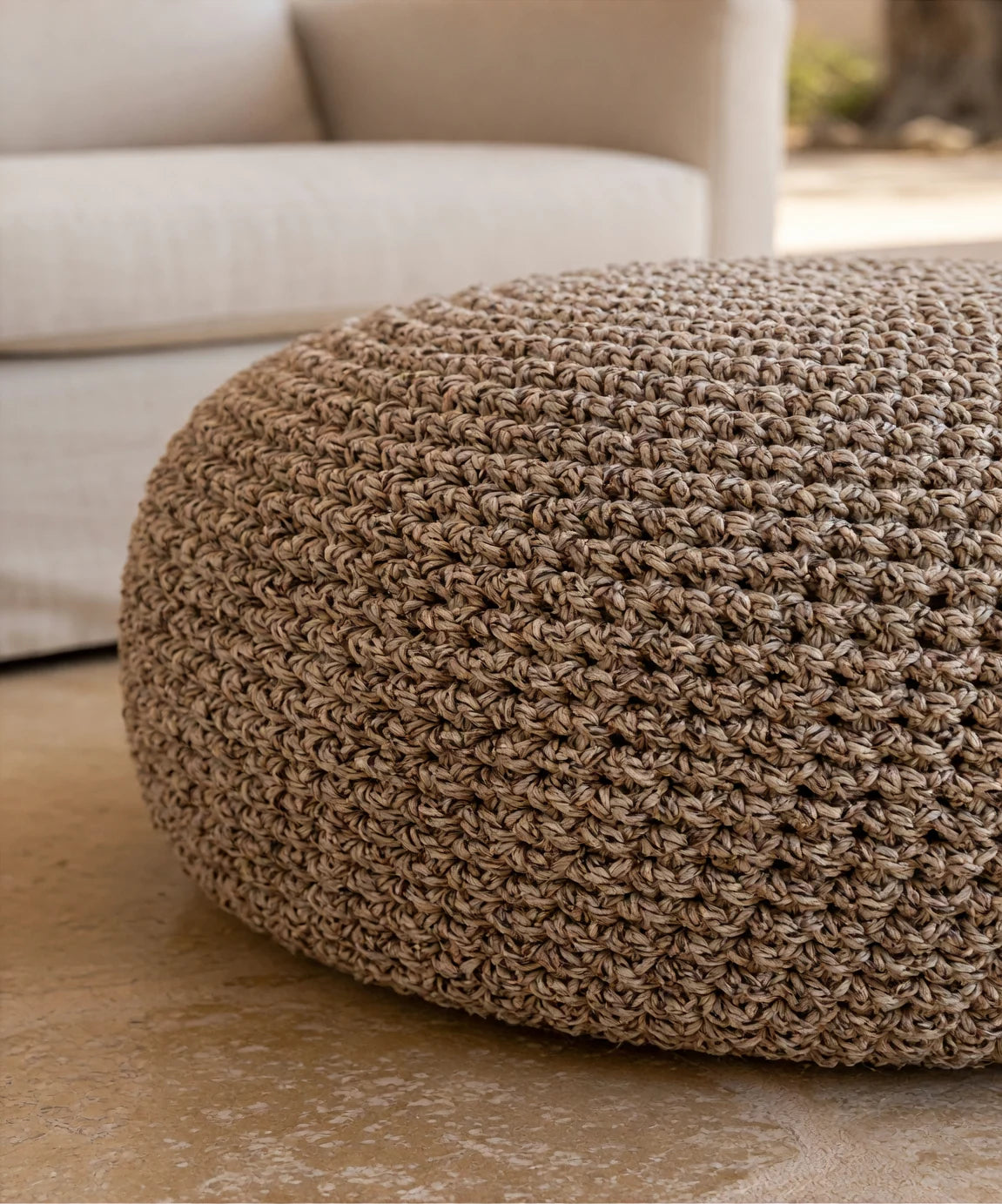 Close editorial view of the mottled crochet texture of the Looping Home pouf